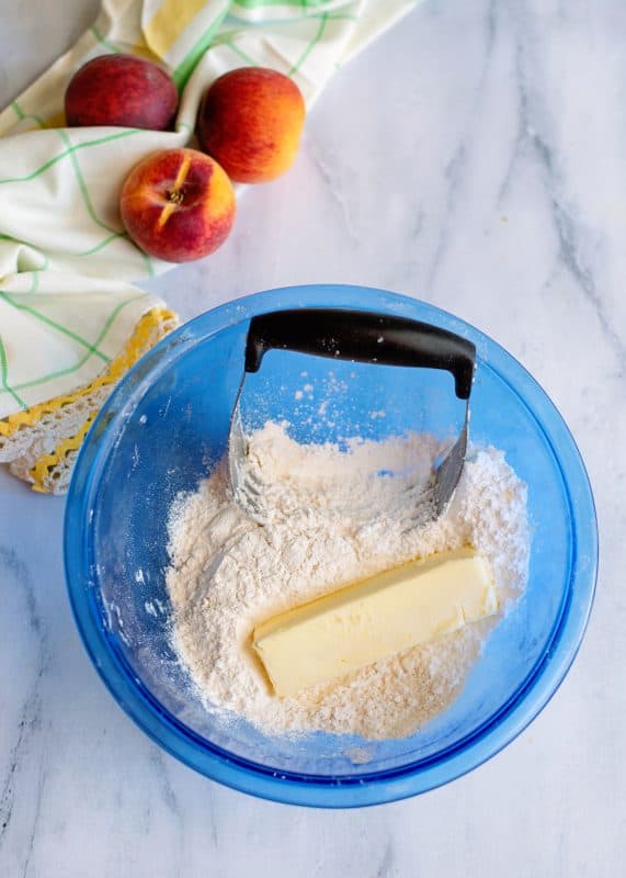 butter in a bowl of the streusel topping for the peach bars