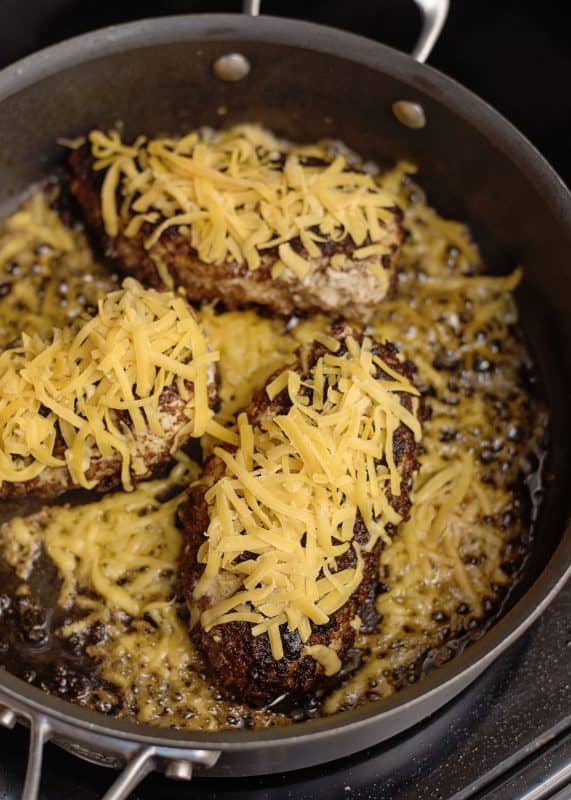 Place cheese on top of each blackened chicken breast in skillet.