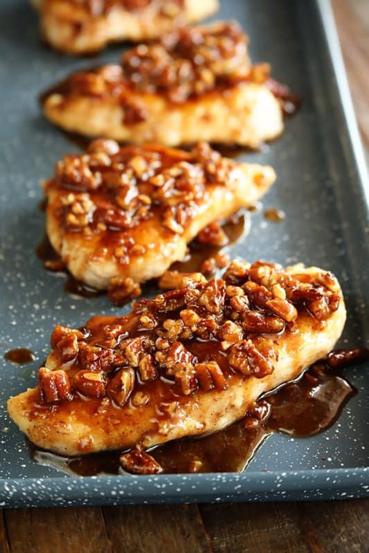 honey garlic pecan chicken breasts on a baking sheet 