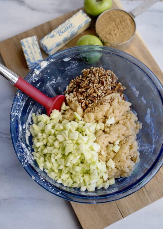 Add chopped apples and pecans to the apple dapple cake batter.