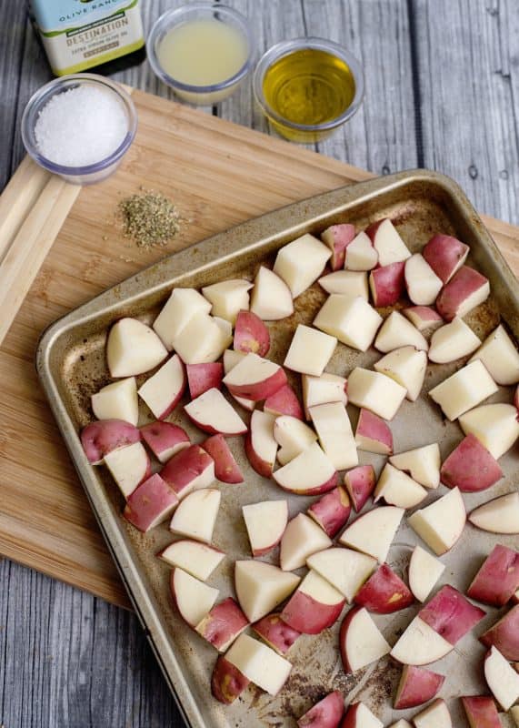 Add single layer of potatoes to baking sheet.