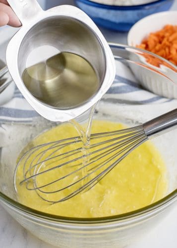 Whisk together eggs and sugar, then add oil and vanilla.