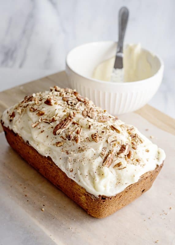 Frost cooled carrot cake loaf and add more pecans (optional).