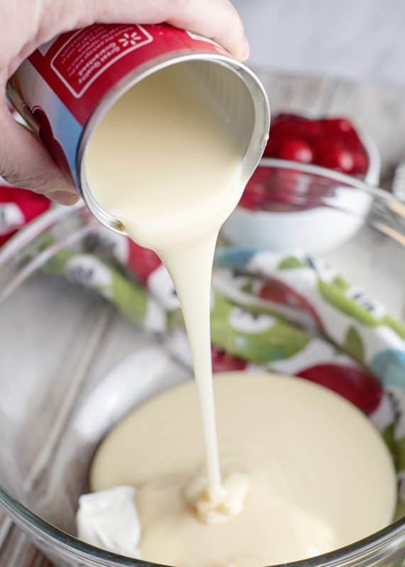 Place condensed milk and cream cheese in mixing bowl.