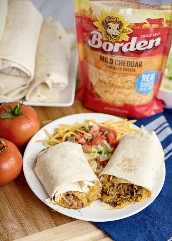 cheesy beef and bean burrito with tomatoes and cheese