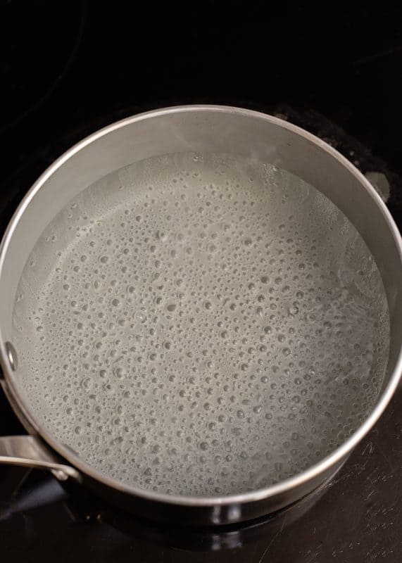 Boil water and baking soda in saucepan.