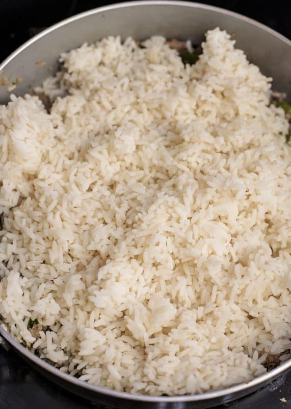 Add cooked rice to skillet.