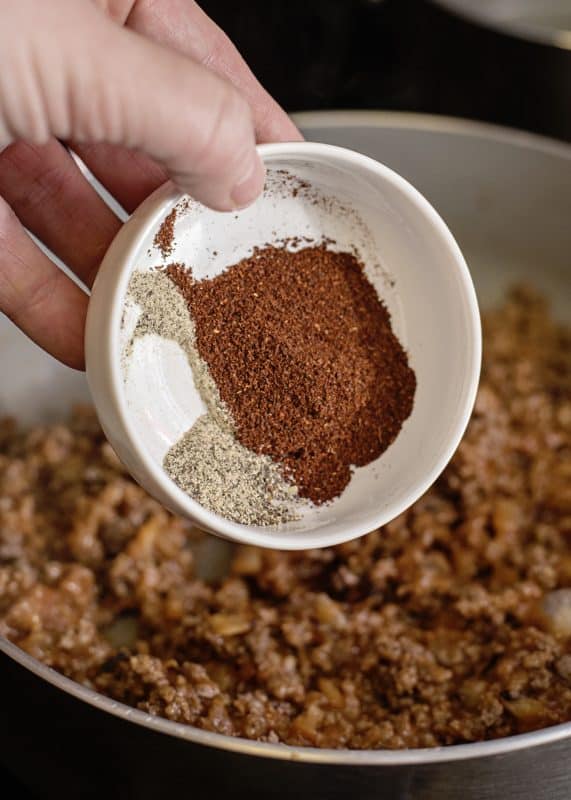adding spices to meat mixture