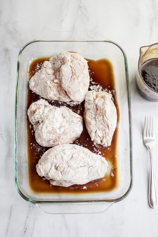 Place coated chicken breast in the baking dish.