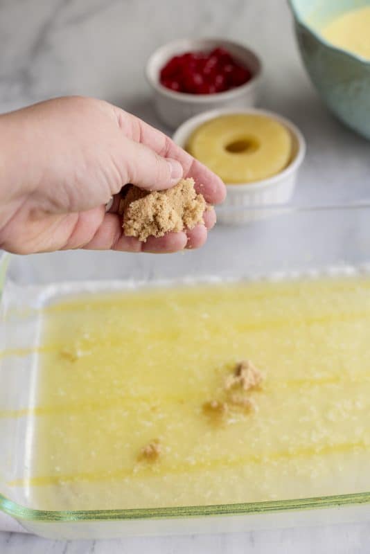Sprinkle brown sugar over butter in pan.