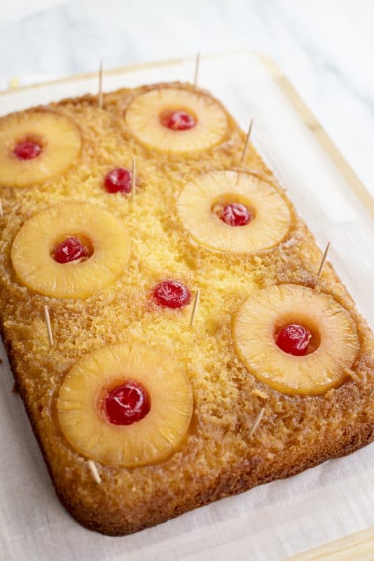 Insert toothpicks into pineapple upside-down cake.