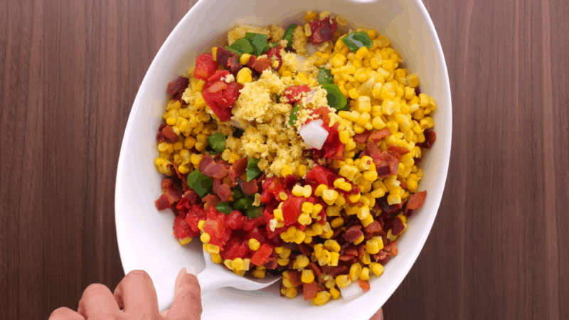 Stirring cornbread salad.