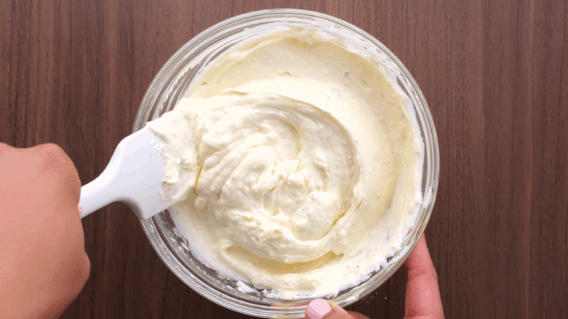 Stirring mayo and ranch dressing mix.