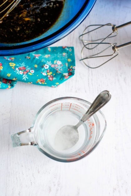 Mixing water and baking soda together for shoofly pie.