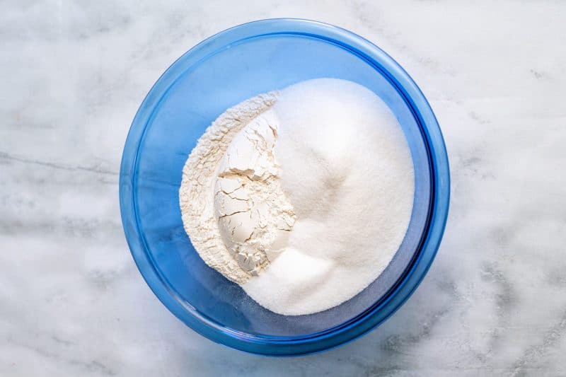 Stir together self-rising flour and sugar in a mixing bowl.