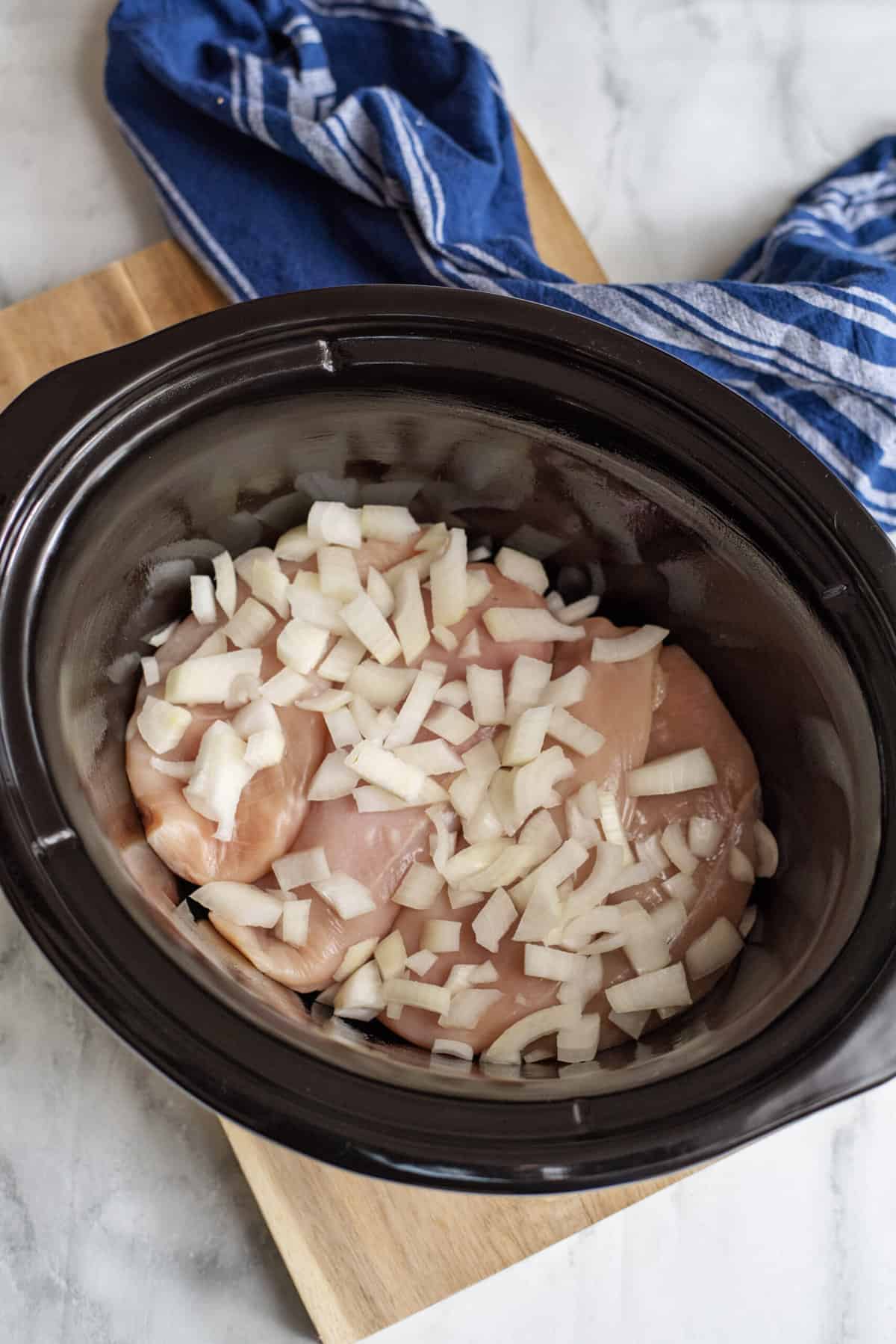Place chicken and onion in slow cooker.