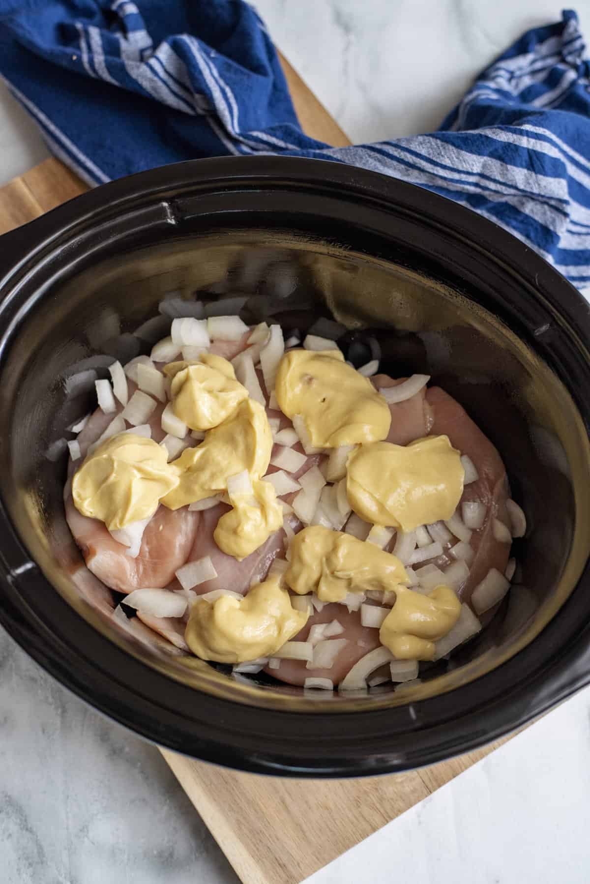 Add cream of chicken soup to slow cooker.
