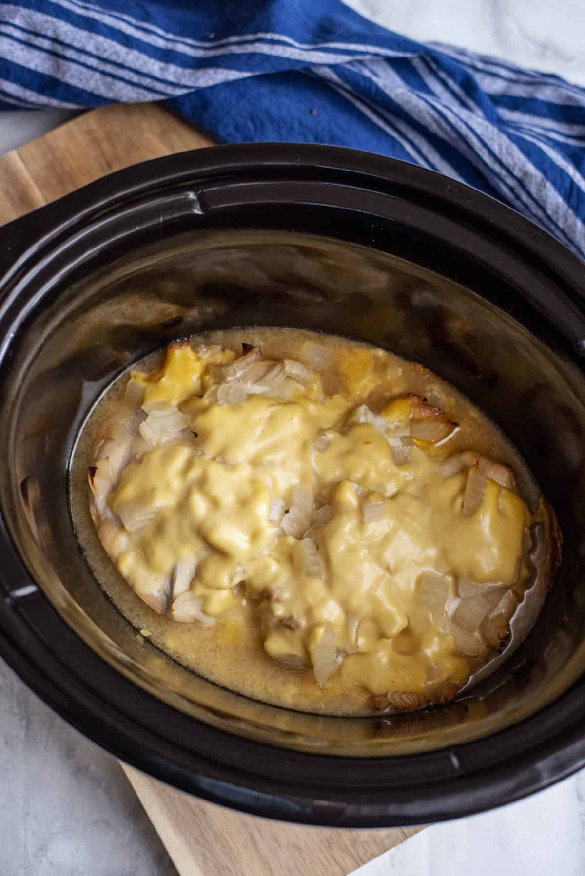 Cheesy chicken and rice in slow cooker.