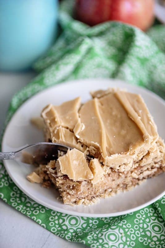 Slice of apple cake with caramel frosting.