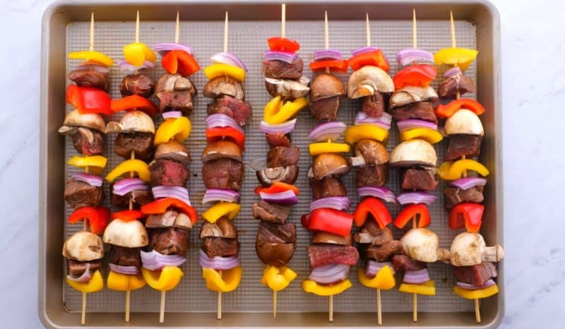 Oven Steak Kabobs - A special meal on a budget Steak kabobs on a baking tray.