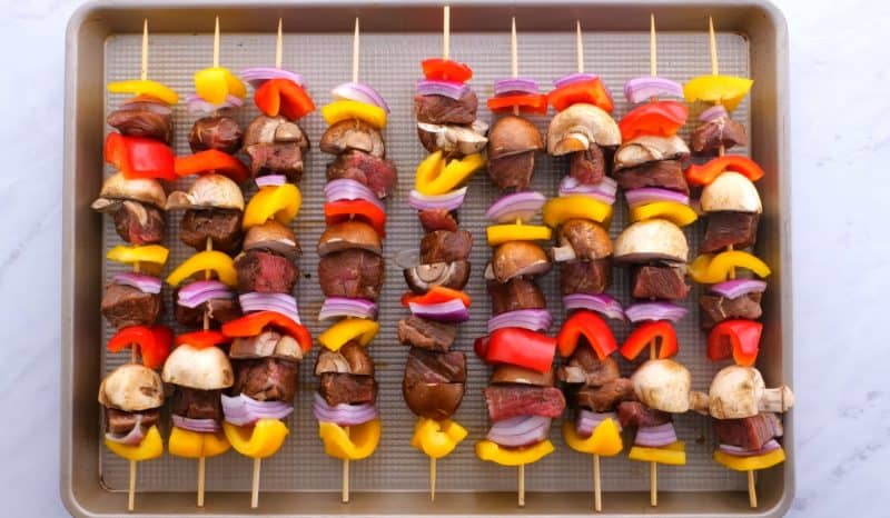 Steak kabobs on a baking tray.