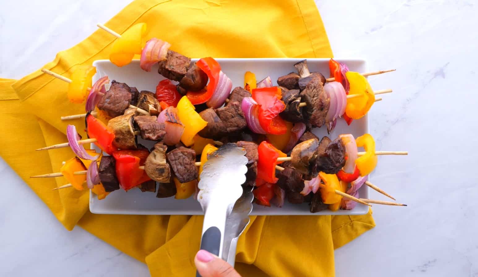 Plate of steak kabobs.