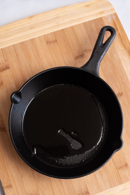 add oil to your preheated cast iron skillet.