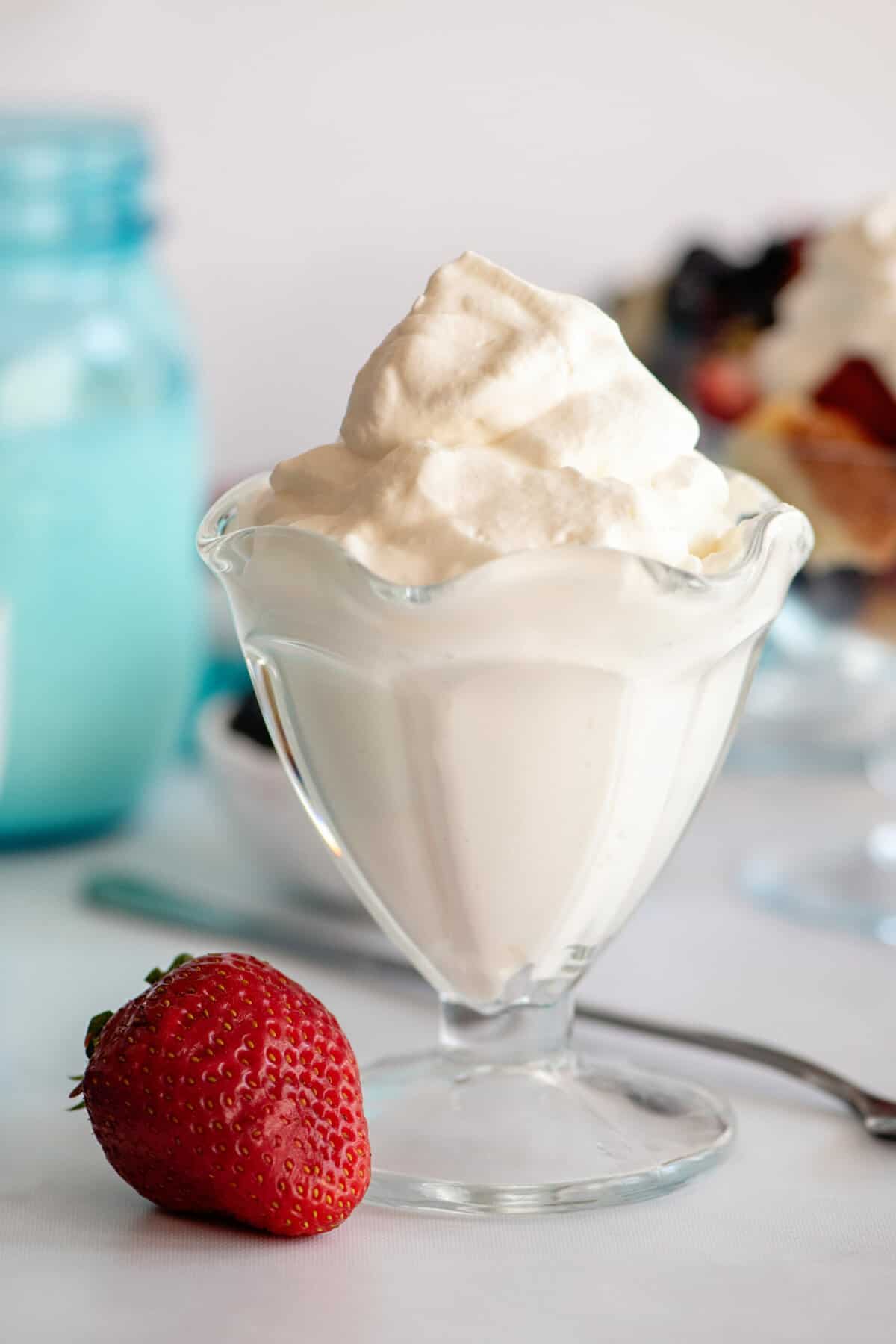 Glass filled with homemade whipped cream.