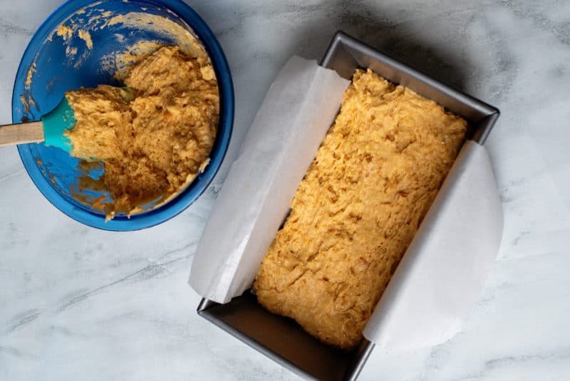 pour half of the sweet potato cake mix into the loaf pan.