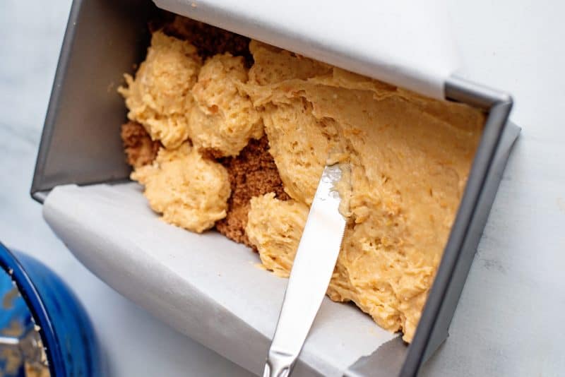 spread sweet potato cake batter to edges using a knife.