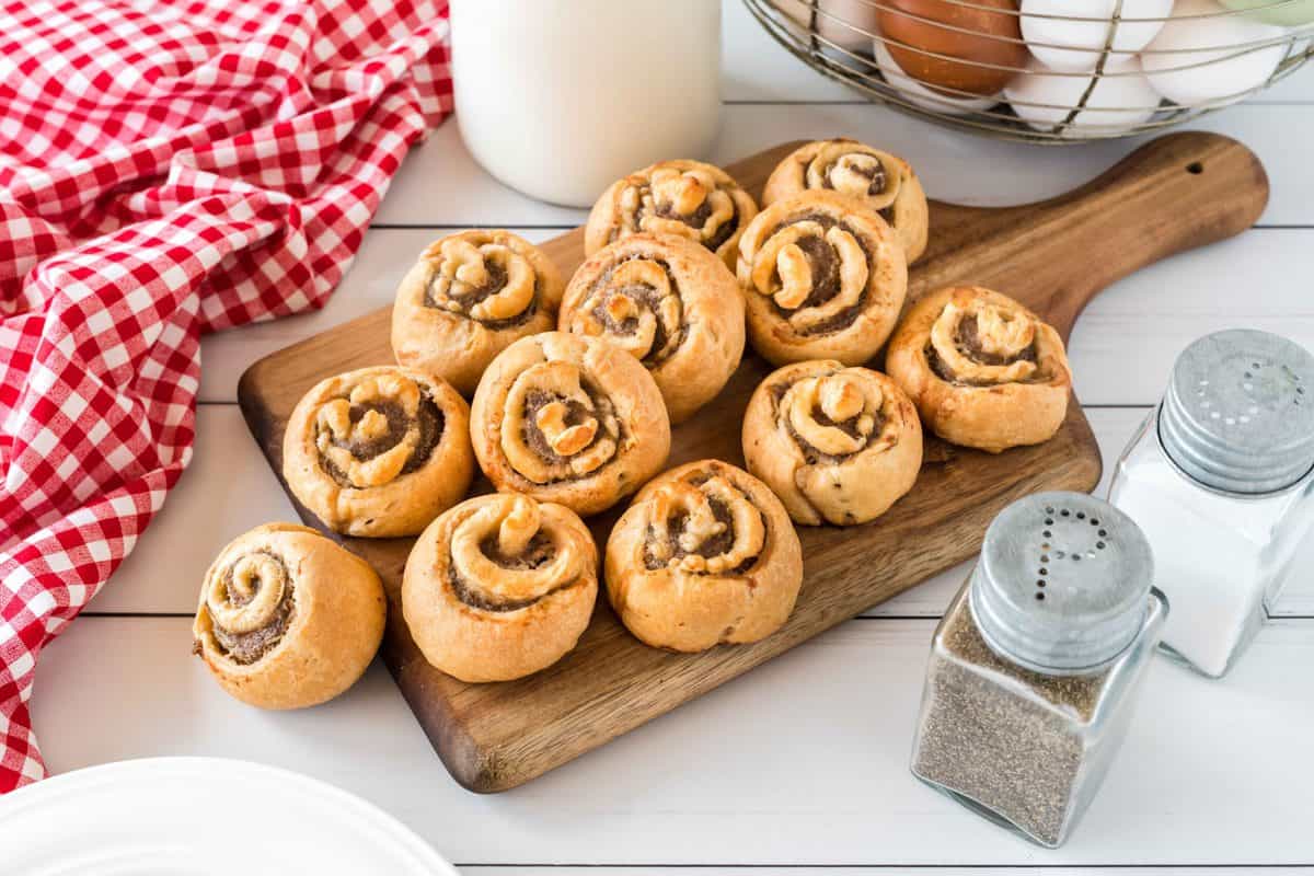 Sausage pinwheels on wooden board.