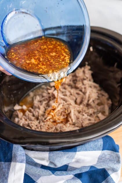 Pour sauce over pulled pork in slow cooker.