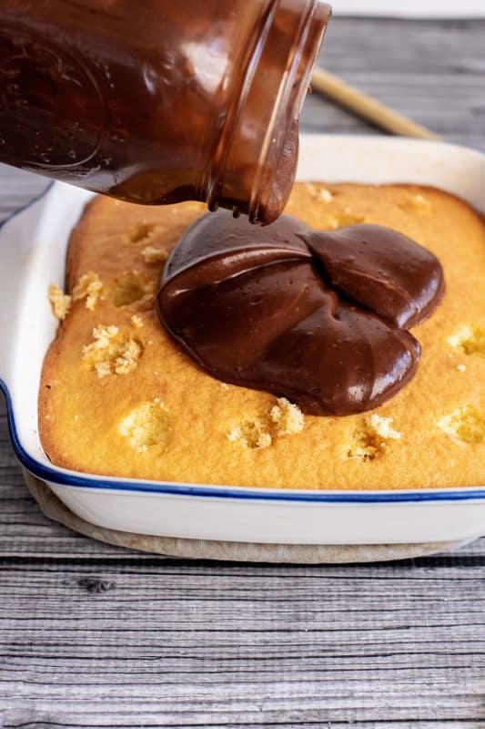 pouring pudding on the cake batter