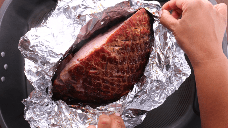 Baked ham in tray.