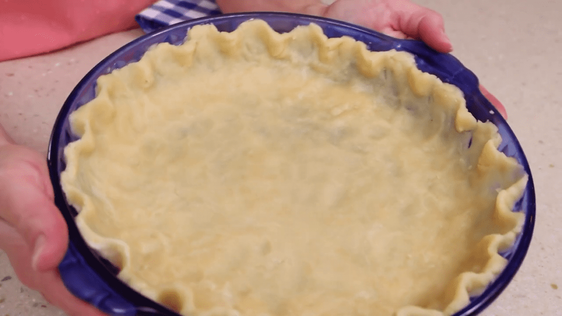 Homemade pie crust in a pie dish.