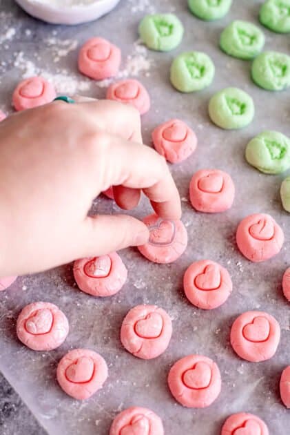 Press stamps into cream cheese mints.