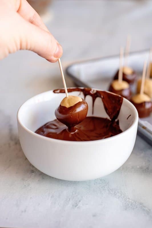 dipping peanut butter balls in chocolate