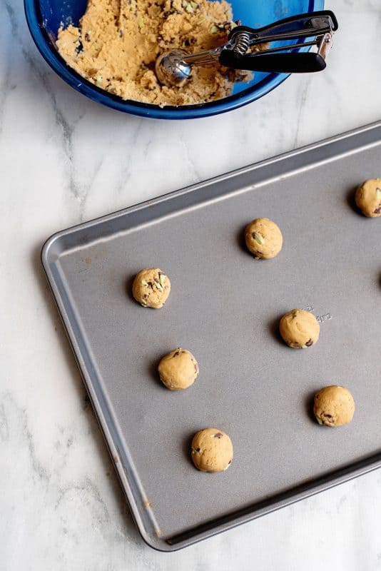 scoop out mint chocolate chip cookie dough on sheet