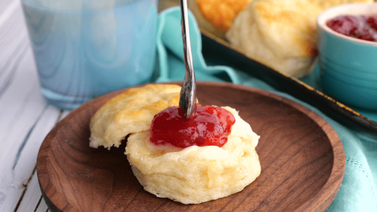 Adding jam to homemade buttermilk biscuit.