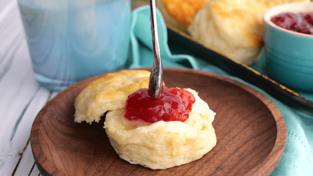 Adding jam to homemade buttermilk biscuit.