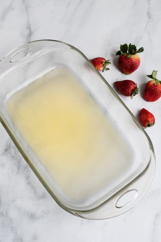 Pour melted butter into baking dish.