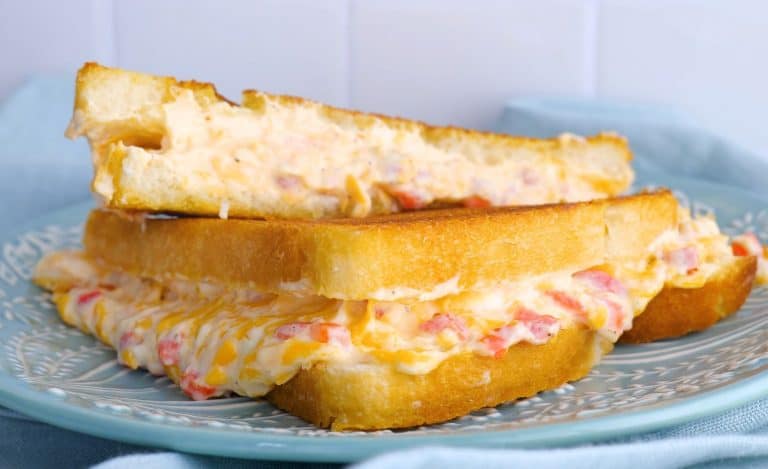 Grilled pimento cheese sandwich on a light blue plate.