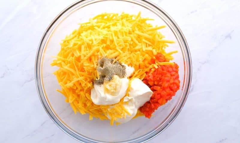 Pimento cheese spread ingredients in bowl.