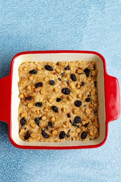 Butterscotch oatmeal raisin cookie dough in a 8x8 baking dish ready to bake.