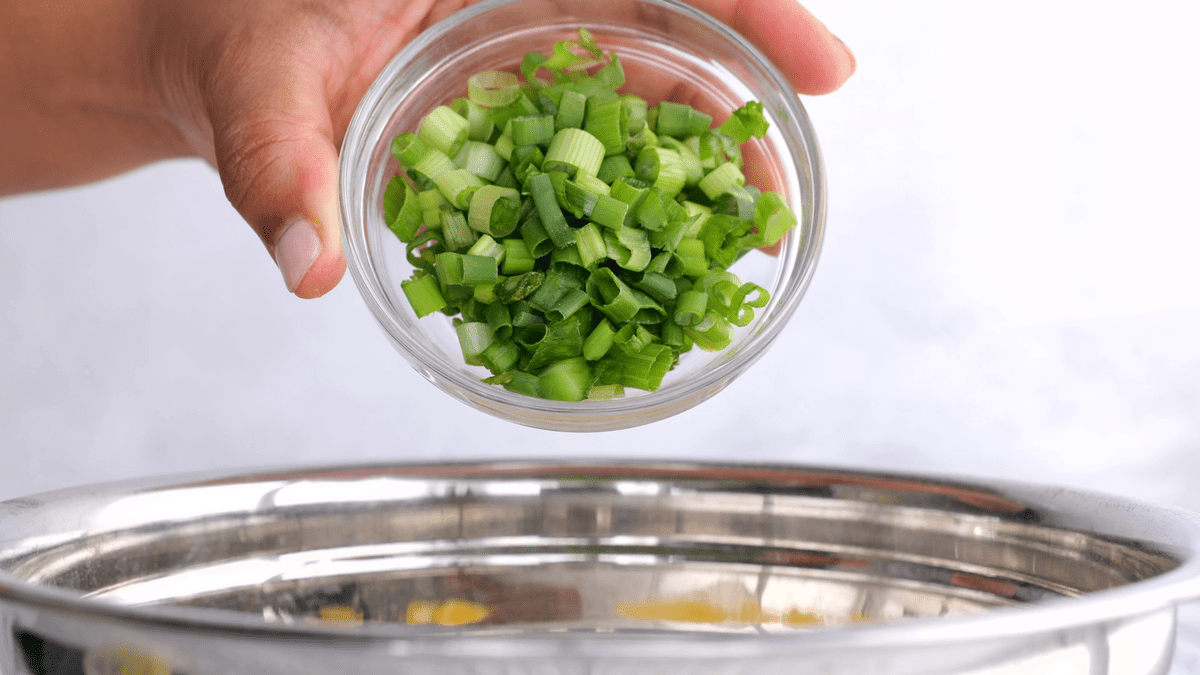 Add green onion to the mixing bowl.