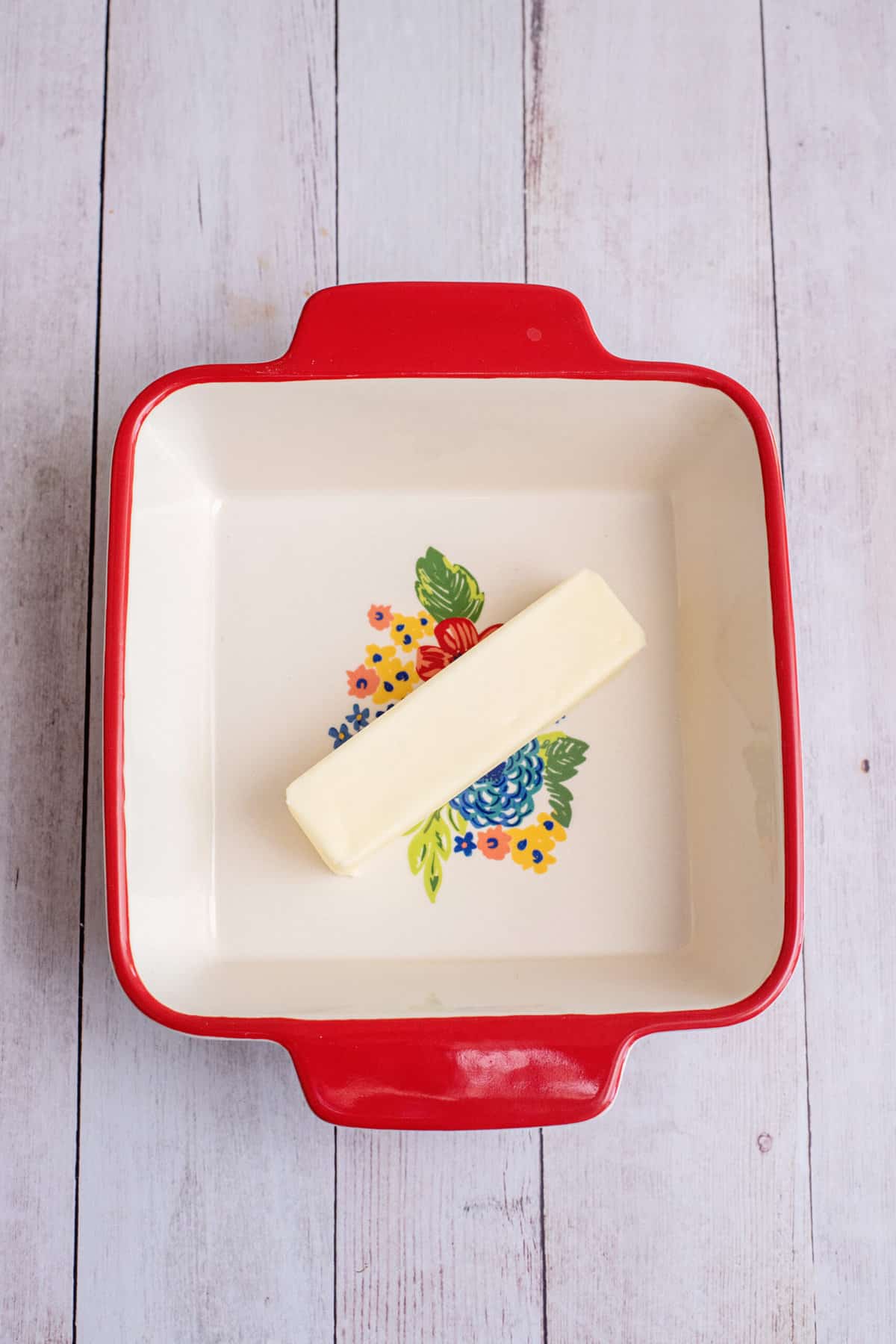 Melt stick of butter in baking dish in preheating oven.