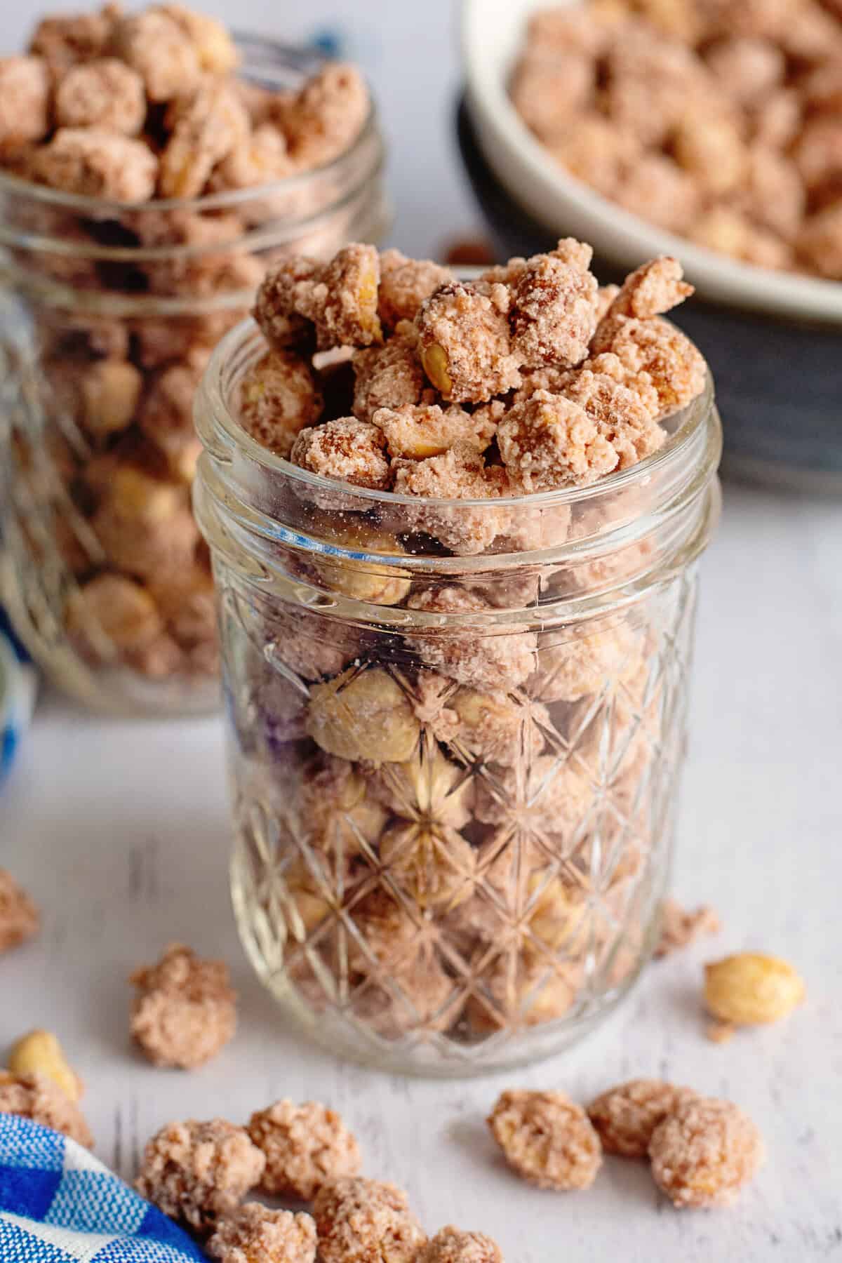 A glass mason jar of candied peanuts.