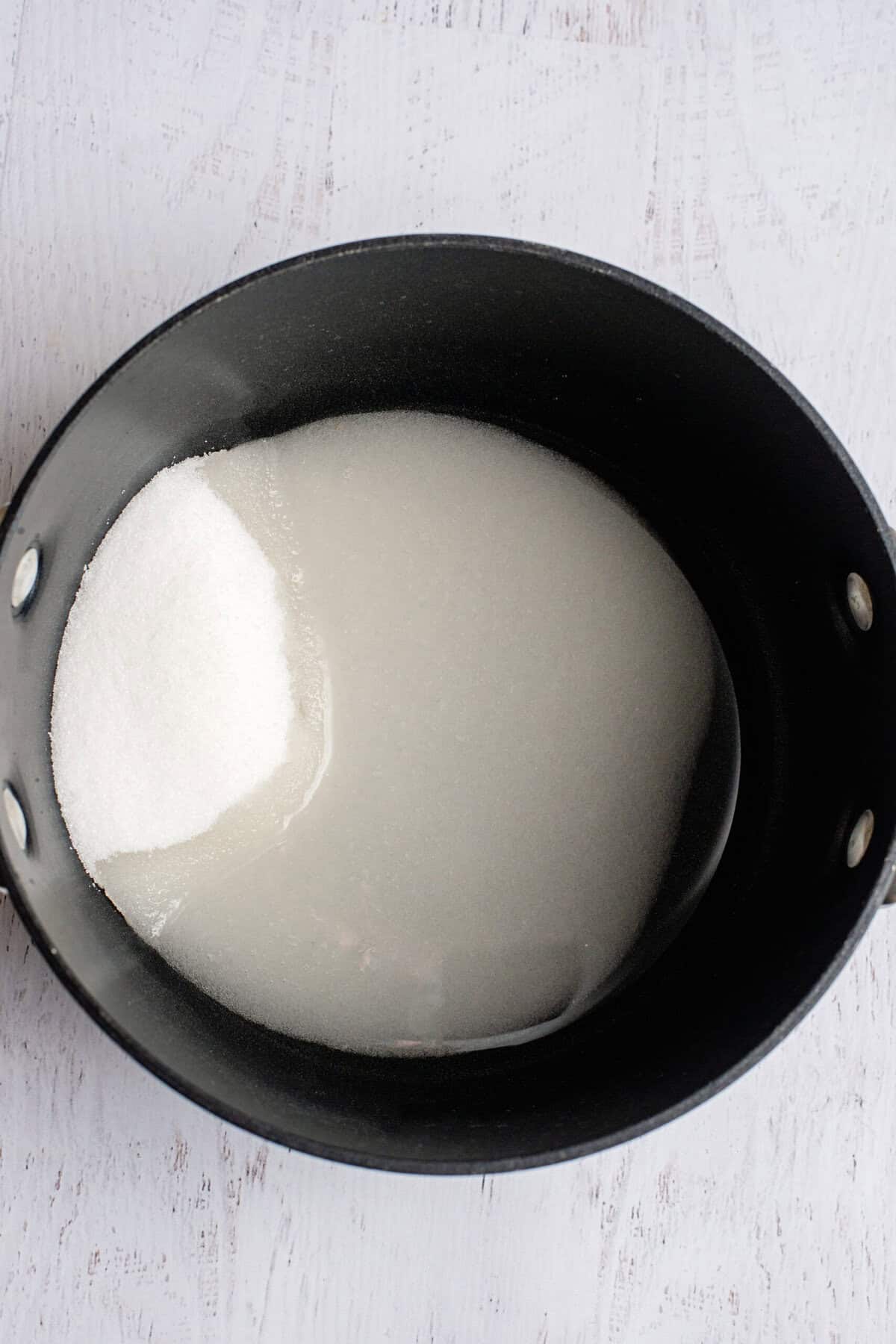 Sugar in water in a large pot.