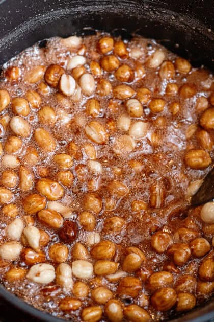 Peanuts boiling in a pot of sugar water.