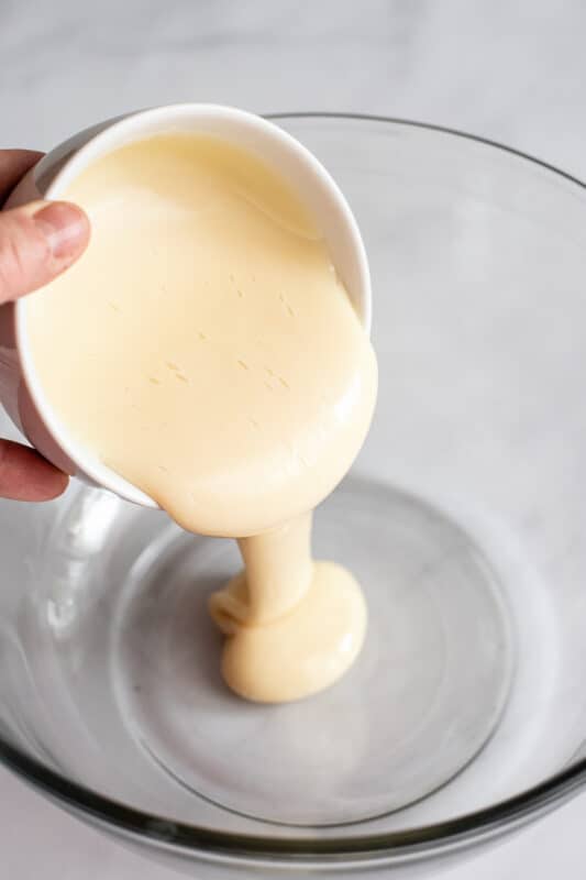 pour sweetened condensed milk in bowl